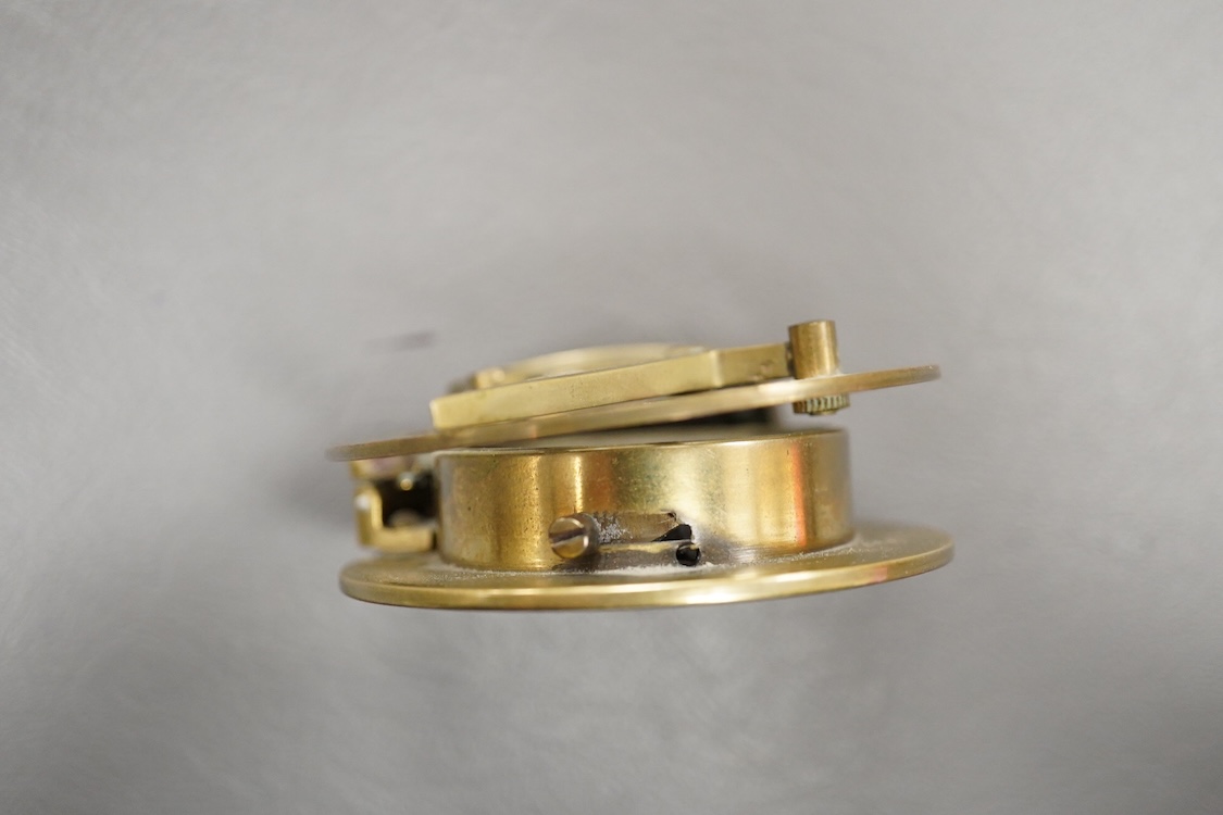 A mid 19th century brass pocket sundial, by F.L. West, 31, Cockspur St., London, with a folding gnomon and latitude scale, 6.5cm diameter